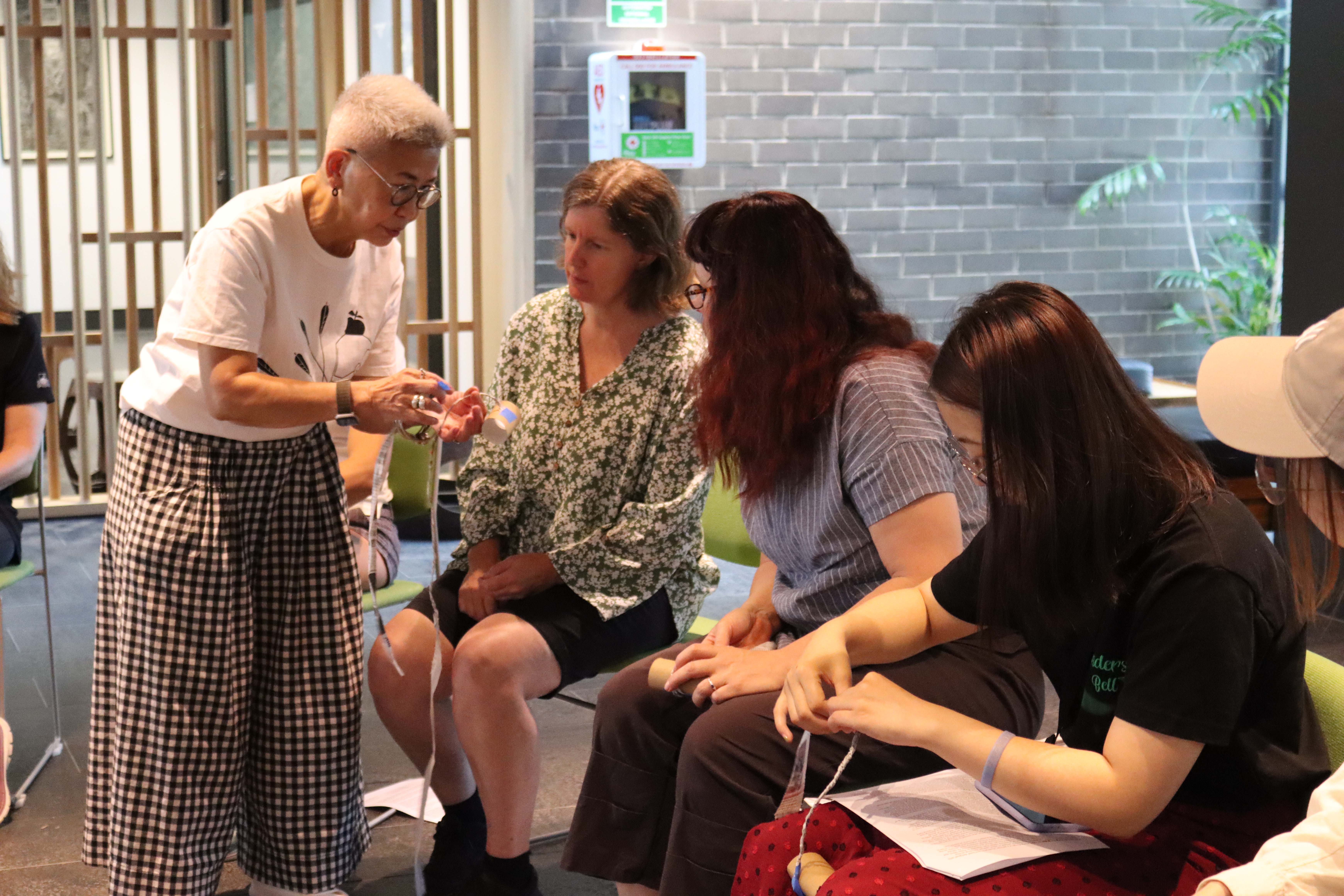Pamela Showing How To Make Newspaper Into Yarn